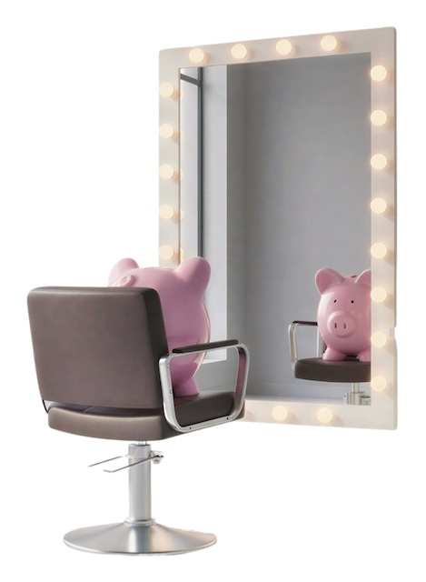 A pink piggy bank sitting in a hair salon chair, looking in a lighted mirror